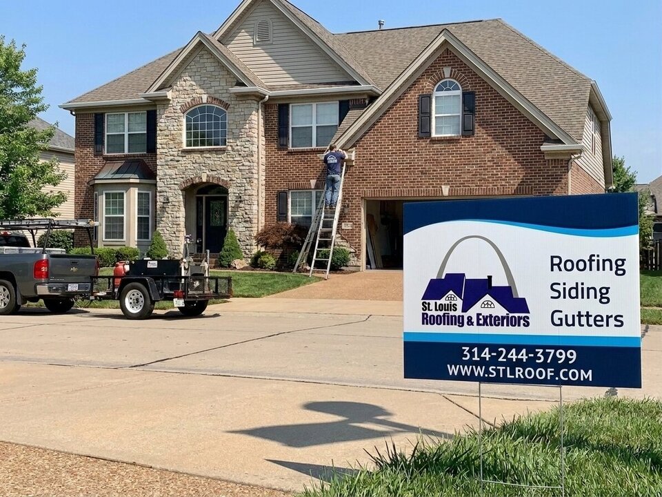 A ladder set against a house eave for a roof inspection.